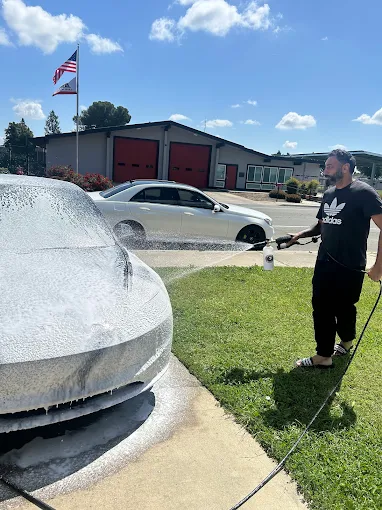 Luxury car detailing being performed outdoors